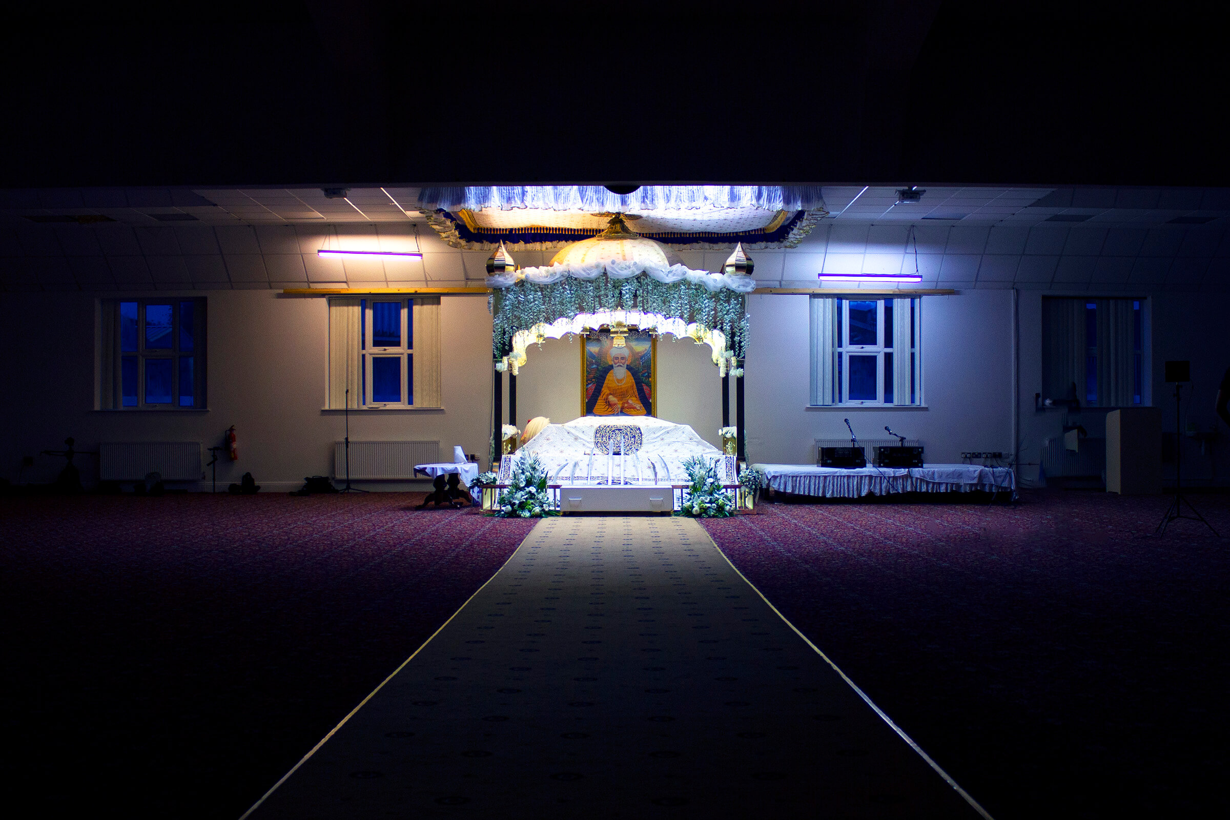 Early morning shot of empty Gurudwara Darbar hall dimly lit
