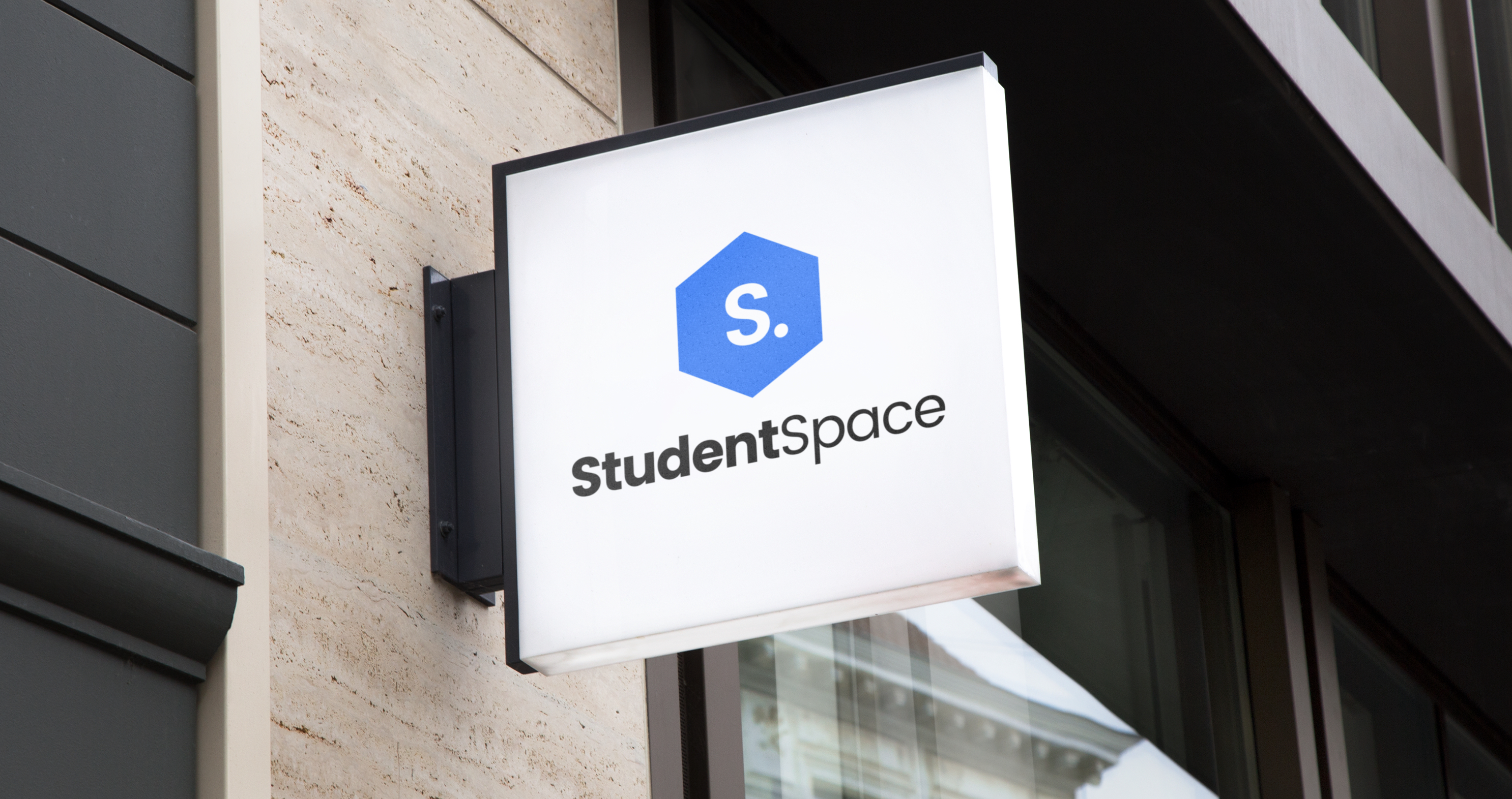 Lightbox sign outside a building showcasing a student space logo