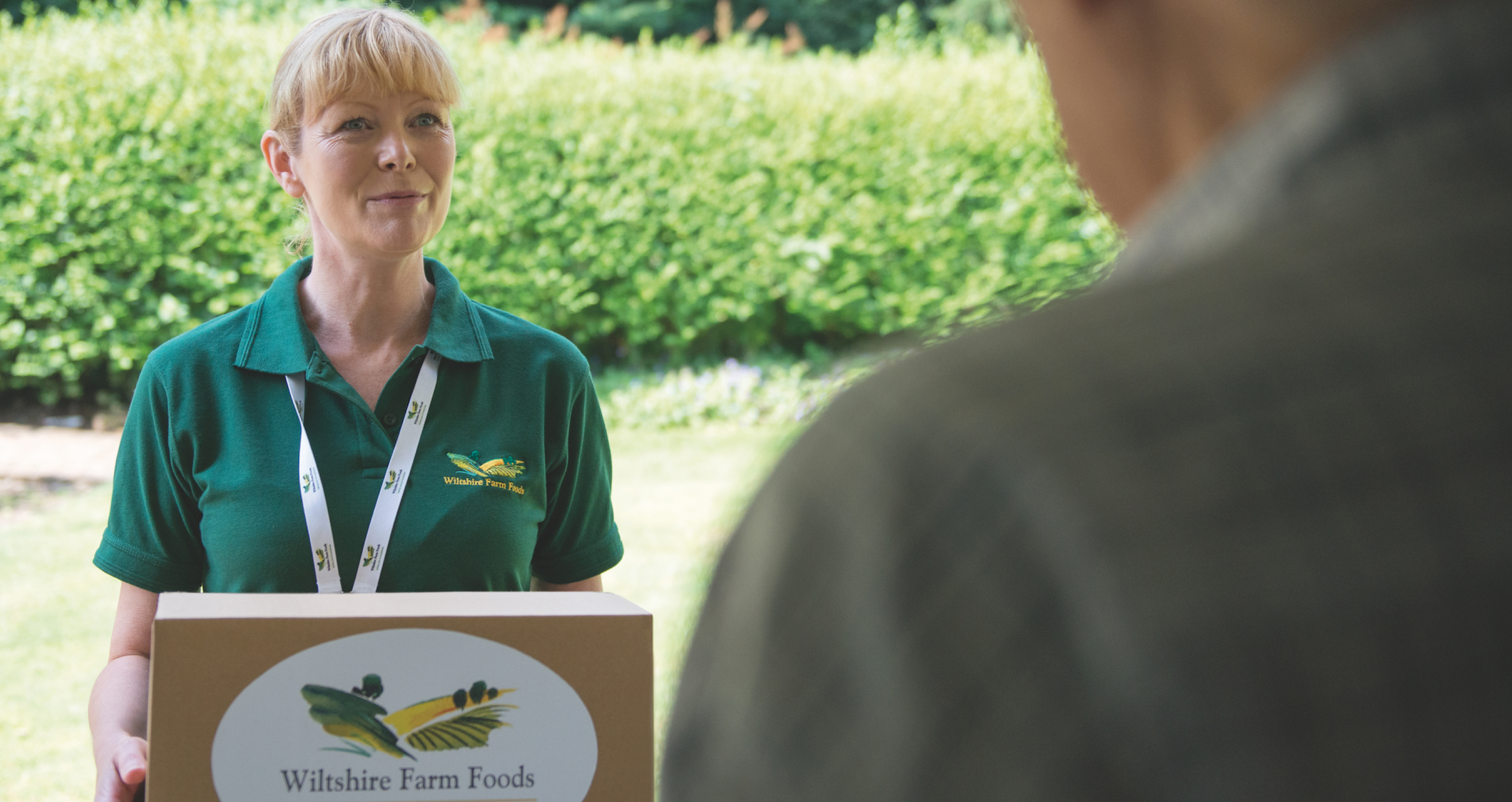 Wiltshire Farm Food delivery lady handing food over to client